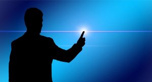 silhouette of a man holding is finger on a distant light